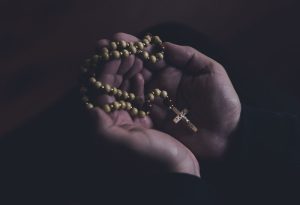 Cross jewellery in a pair of hands