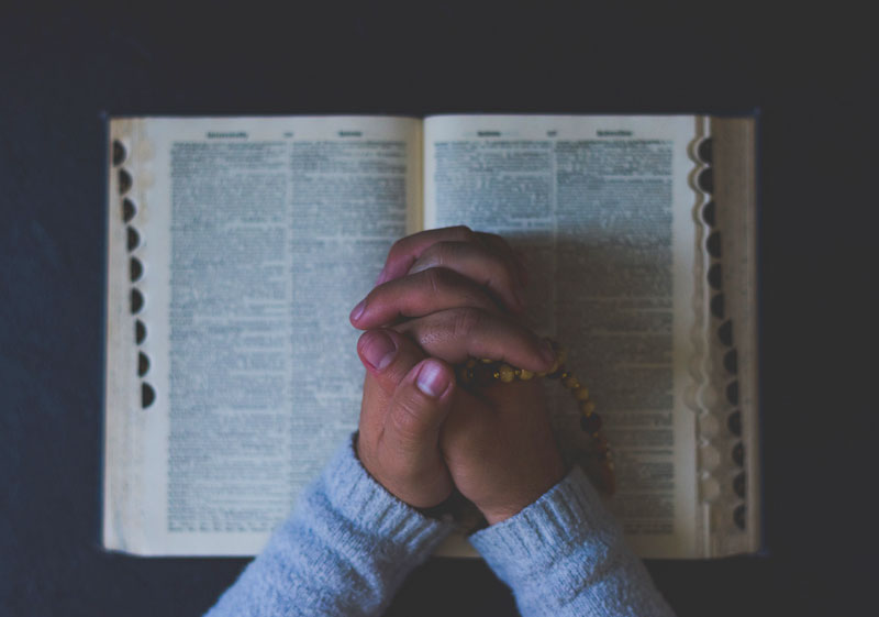 A prayer on top of an open bible